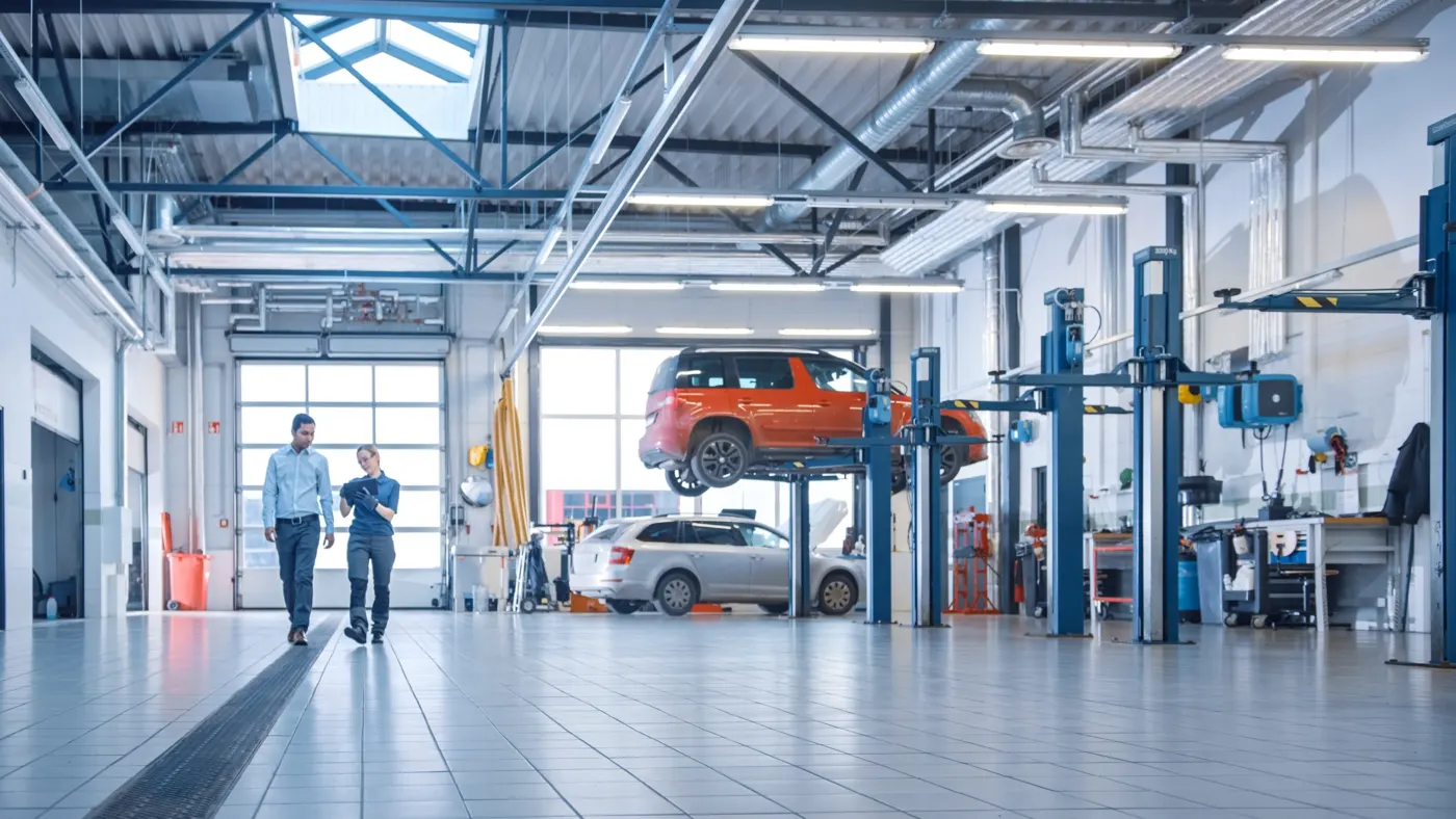 A repair workshop with a car raised on a two-post lift (general scene)